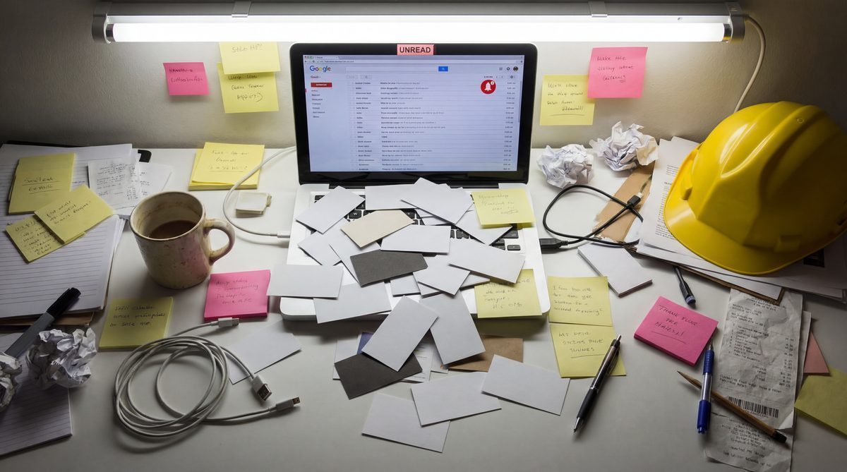 Cluttered contractor desk with missed calls and unread messages